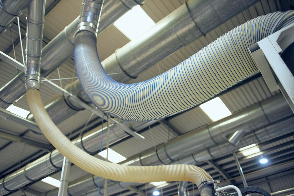 HVAC technician performing commercial air duct sanitizing in an Aurora office building
