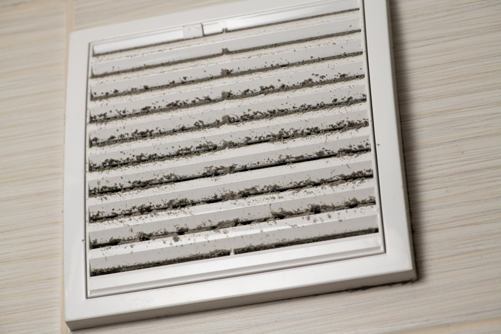 HVAC technician inspecting Glenview air ducts for mold hazards caused by summer humidity and dust buildup