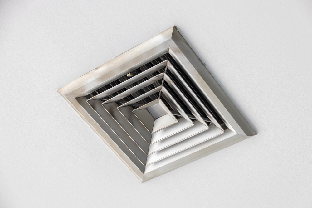 HVAC technician inspecting a Glenview AC with a musty smell caused by dirty coils and air ducts
