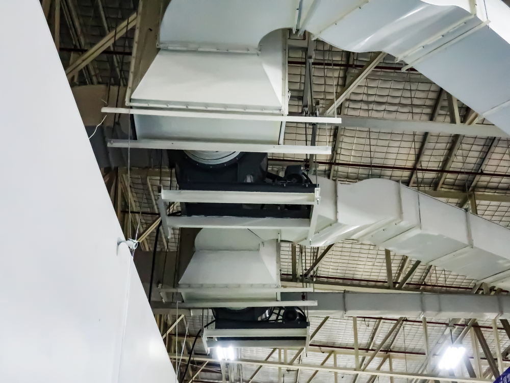 HVAC technician performing a multi-point video air duct inspection inside residential ductwork