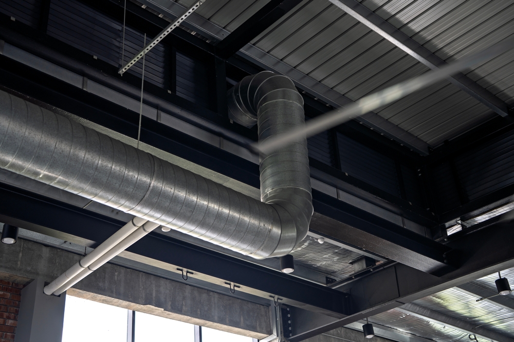 HVAC technician inspecting Aurora ductwork for musty odors caused by summer humidity