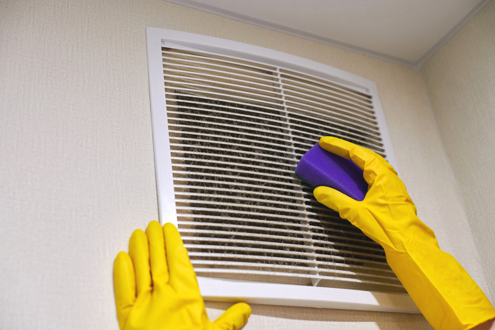 HVAC technician performing post-construction duct cleaning in a newly built Aurora home