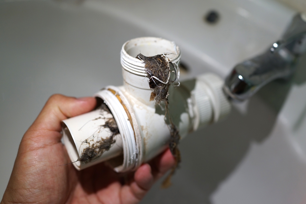 Professional vent cleaning technician removing animal nesting and bird debris from Northbrook vents