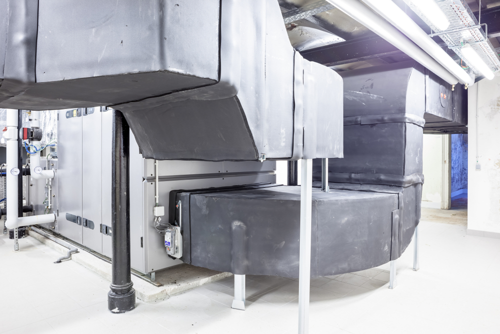 HVAC technician inspecting a commercial ventilation system during health checks in Aurora
